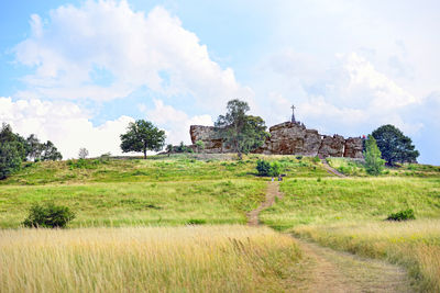 Built structure on field against sky