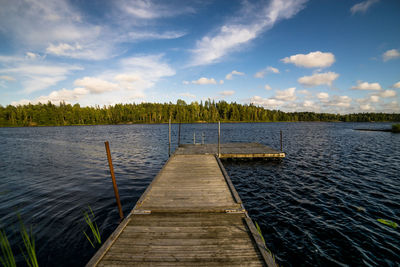 Pier over lake against sky