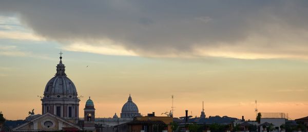 Cathedral against st peter basilica at sunset