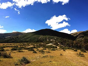 Scenic view of mountains against blue sky