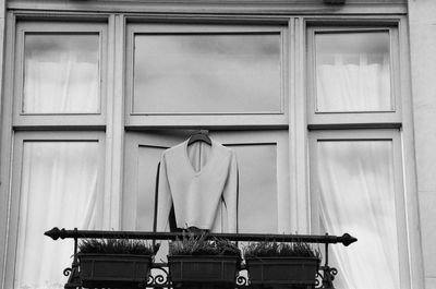 Pullover hanging outside a window, monochrome, absence 