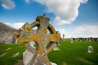 View of cross on cemetery against sky