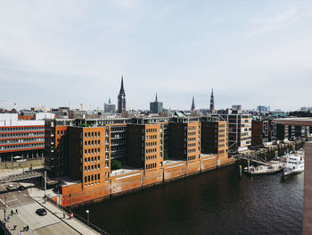 View of buildings at waterfront against sky