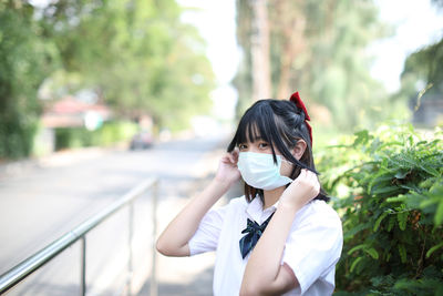 Portrait of young woman standing outdoors