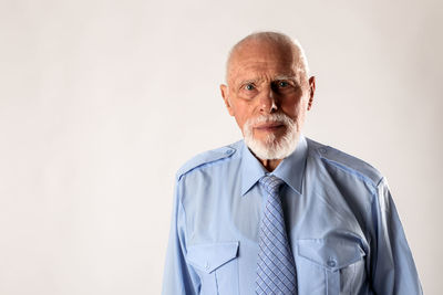 Portrait of man standing against white background