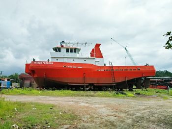 Red boat against sky