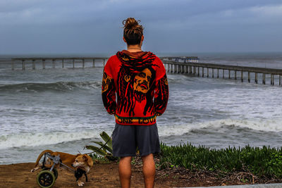 Rear view of woman standing on beach