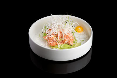 Close-up of food in container against black background
