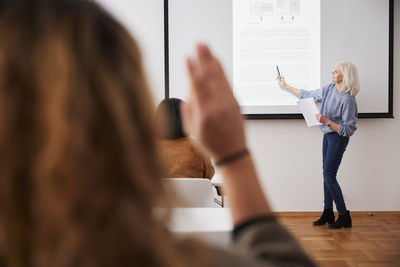 Woman giving presentation at seminar