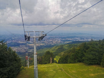 Gondola on landscape against maribor's sky