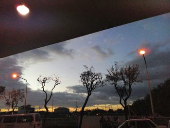 View of illuminated street lights at dusk