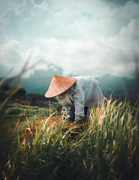 Scenic view of hat on field against sky
