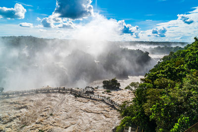 Panoramic view of waterfall against sky