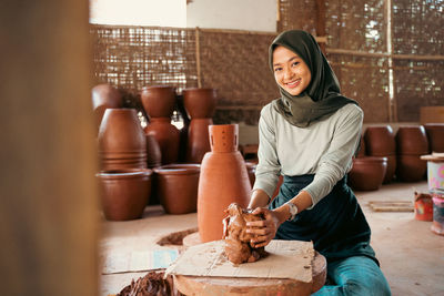 Portrait of young woman working at workshop