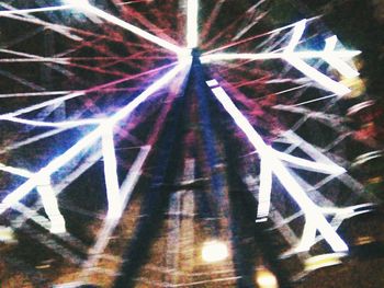 Illuminated ferris wheel at night