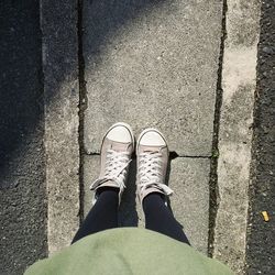 Low section of person standing on tiled floor