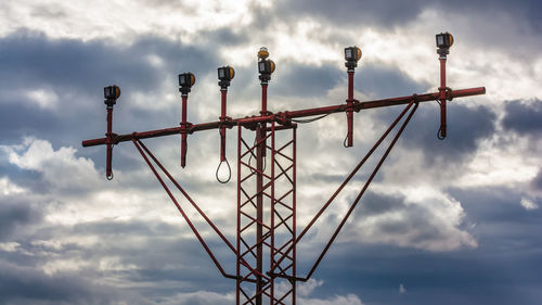 Low angle view of silhouette rusty metal against sky