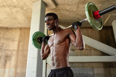 Portrait of young woman exercising in gym