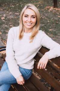 Portrait of smiling young woman sitting outdoors