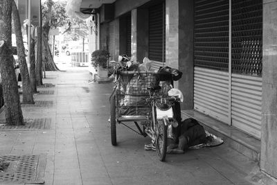 Man sitting on street in city