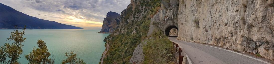 Panoramic view of road by mountains against sky