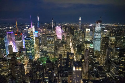 High angle view of illuminated cityscape against sky at night