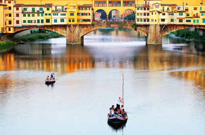 People on bridge over river