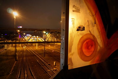 Railway tracks at railroad station at night