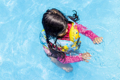 High angle view of girl swimming in pool