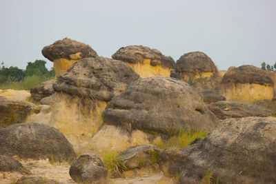 Low angle view of rocks against clear sky