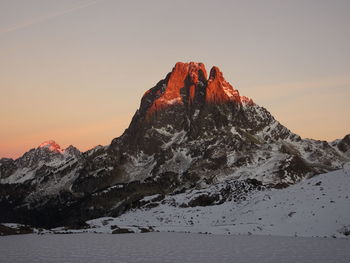 Scenic view of snowcapped mountain against sky during sunset