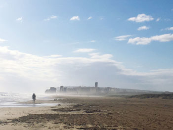 Man standing on land against sky