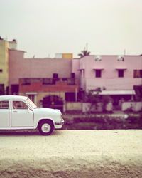 Car on street against buildings in city