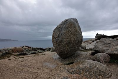 Rocks on beach against sky