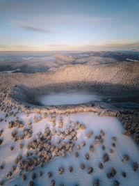 Aerial view of land against sky during winter