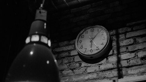 Low angle view of clock on wall