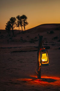Light trails on desert against sky during sunset