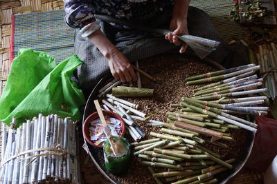High angle view of man making beedi in workshop