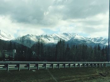 Scenic view of mountains against cloudy sky