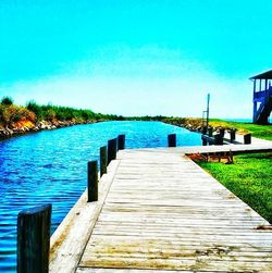 Scenic view of lake against clear blue sky