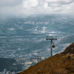 Cable car on mountains against sky