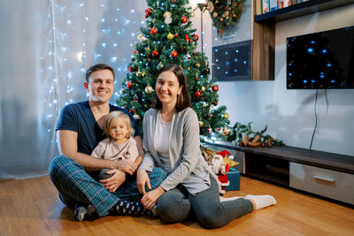 Mother and christmas tree at home