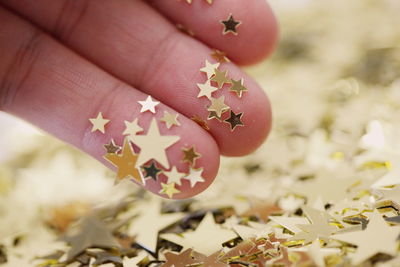 Cropped image of person with golden star shapes