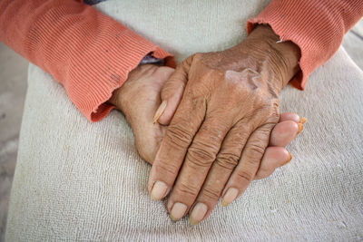 Midsection of woman holding hands