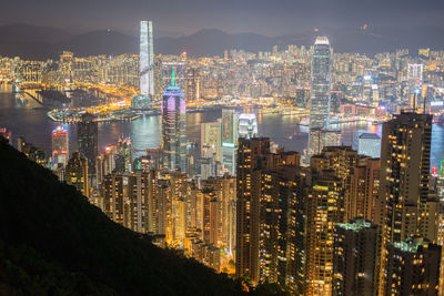 High angle view of illuminated city buildings at night