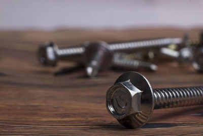 Close-up of nut and bolts on table