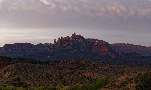 Rock formations on landscape against sky