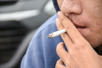 Close-up of man smoking cigarette