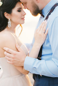 Midsection of bride holding hands