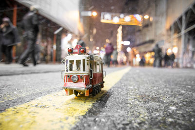 Toy  tram car on road in city
